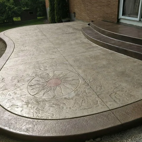 Stamped patio with sun medallion and steps